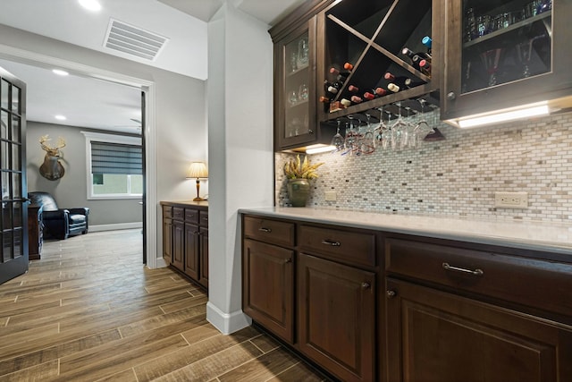 8217 American Way, Denton, TX 76207 - indoor dry bar with wood tiled floors, tasteful backsplash, baseboards, and recessed lighting