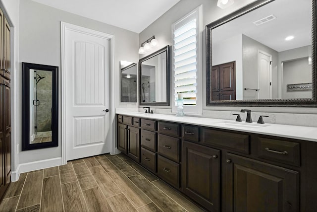 8217 American Way, Denton, TX 76207 - full bathroom featuring double vanity, wood tiled floors, a shower, and baseboards
