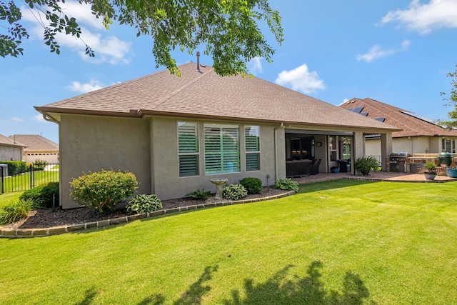 8217 American Way, Denton, TX 76207 - back of property with a patio, stucco siding, a shingled roof, and exterior kitchen