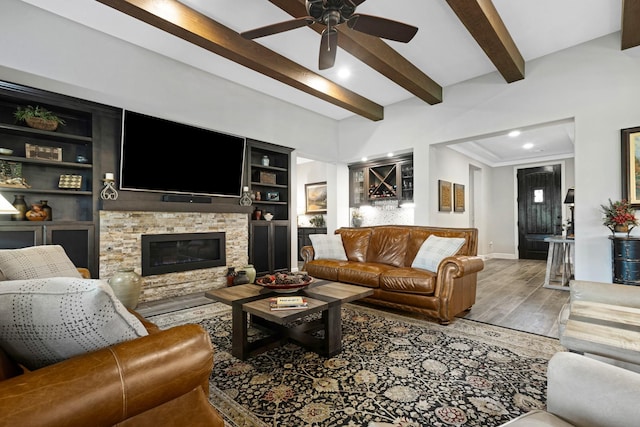 8217 American Way, Denton, TX 76207 - living area with baseboards, a ceiling fan, wood finished floors, beamed ceiling, and a fireplace