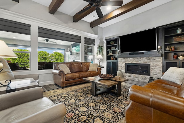 8217 American Way, Denton, TX 76207 - living room featuring a ceiling fan, beamed ceiling, wood finished floors, a stone fireplace, and built in shelves
