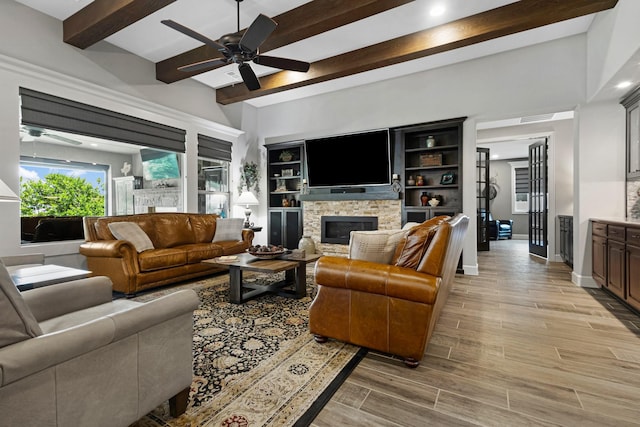 8217 American Way, Denton, TX 76207 - living area featuring ceiling fan, beam ceiling, a fireplace, light wood-style flooring, and baseboards