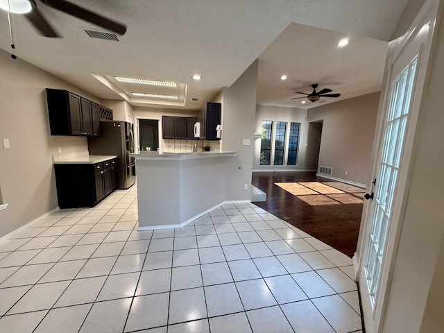 1001 Schrade Trl, Mesquite, TX 75181 - kitchen with ceiling fan, light tile patterned floors, open floor plan, light countertops, and recessed lighting