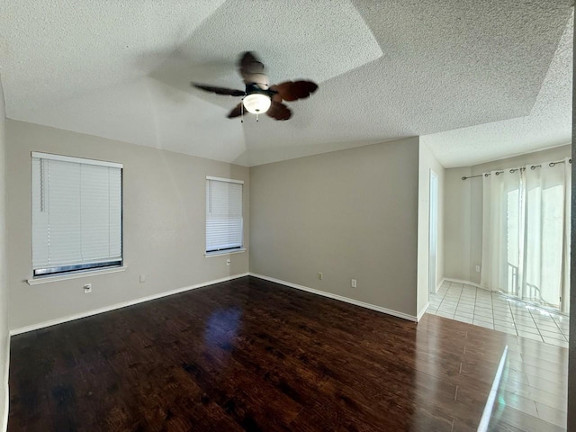 1001 Schrade Trl, Mesquite, TX 75181 - unfurnished room featuring a ceiling fan, wood finished floors, a textured ceiling, baseboards, and vaulted ceiling