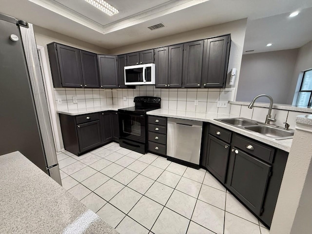 1001 Schrade Trl, Mesquite, TX 75181 - kitchen featuring stainless steel appliances, a sink, backsplash, light tile patterned flooring, and light countertops