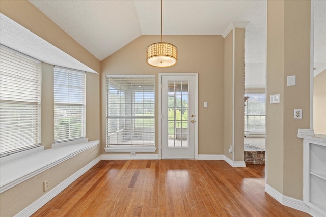 11200 Williamsburg Ln, Frisco, TX 75035 - doorway featuring light wood finished floors, baseboards, and lofted ceiling