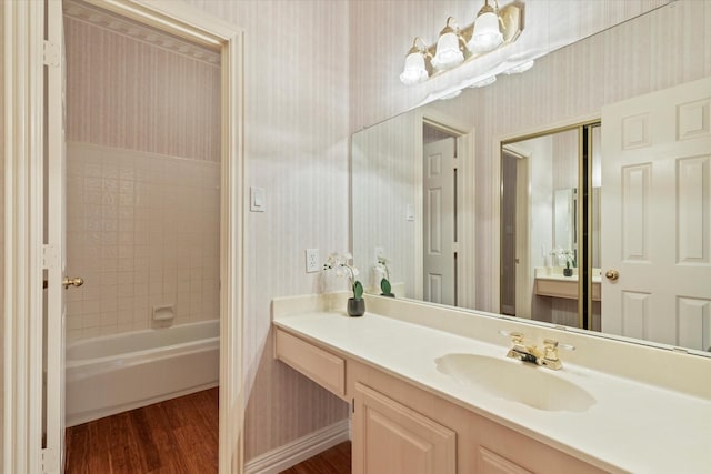 11200 Williamsburg Ln, Frisco, TX 75035 - full bath with wallpapered walls, wood finished floors, and vanity