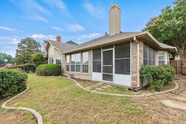 11200 Williamsburg Ln, Frisco, TX 75035 - back of house with a chimney, a sunroom, brick siding, and a shingled roof