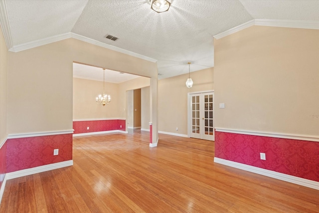 11200 Williamsburg Ln, Frisco, TX 75035 - spare room featuring vaulted ceiling, wood finished floors, a chandelier, baseboards, and crown molding
