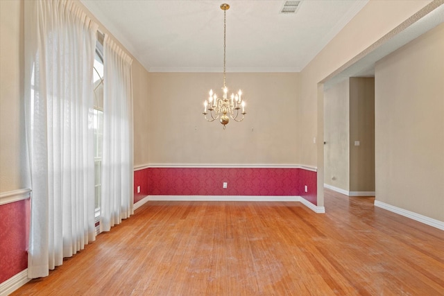 11200 Williamsburg Ln, Frisco, TX 75035 - unfurnished room featuring light wood finished floors, baseboards, a chandelier, and ornamental molding