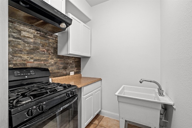 1228 Copano Dr, Allen, TX 75013 - kitchen with black gas range, exhaust hood, white cabinets, light tile patterned floors, and a sink