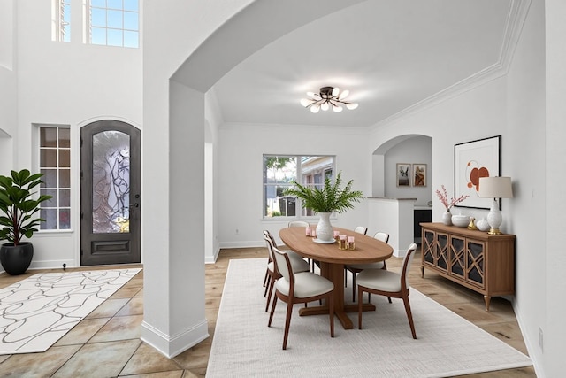 1228 Copano Dr, Allen, TX 75013 - dining room with crown molding, arched walkways, baseboards, and light tile patterned floors