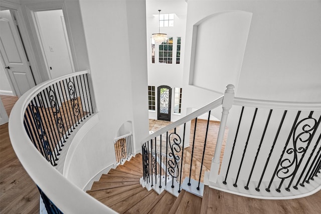 1228 Copano Dr, Allen, TX 75013 - staircase featuring wood finished floors, a towering ceiling, and a chandelier