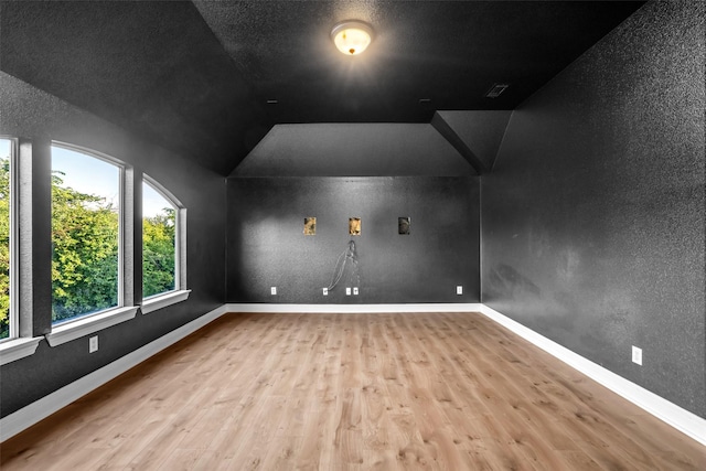 1228 Copano Dr, Allen, TX 75013 - additional living space with wood finished floors, vaulted ceiling, baseboards, and a textured wall