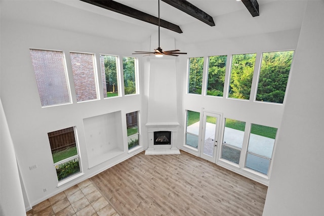 1228 Copano Dr, Allen, TX 75013 - unfurnished living room featuring a towering ceiling, a fireplace, beam ceiling, baseboards, and ceiling fan