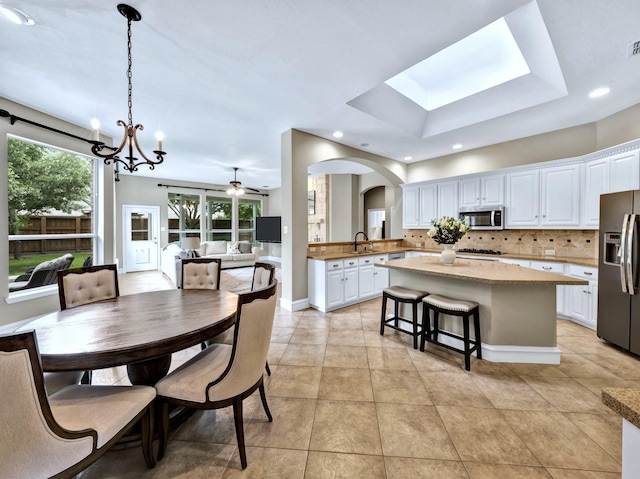 511 Cloud View Ct, Prosper, TX 75078 - dining room featuring arched walkways, light tile patterned floors, recessed lighting, a chandelier, and a raised ceiling