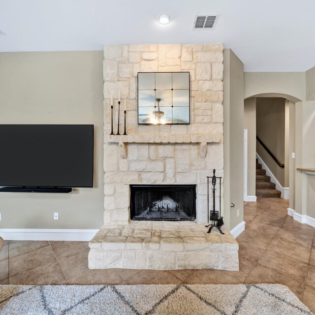 511 Cloud View Ct, Prosper, TX 75078 - unfurnished living room with a stone fireplace, stairs, arched walkways, and tile patterned floors