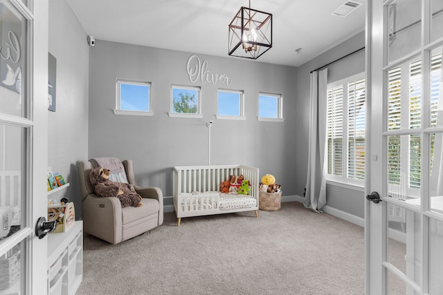 2402 Wilson Dr, Anna, TX 75409 - bedroom with carpet, french doors, multiple windows, and a chandelier