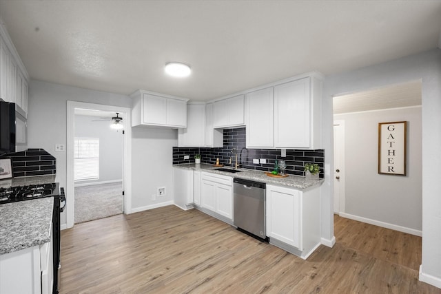 1306 Joslin St, Cleburne, TX 76033 - kitchen featuring dishwasher, gas range oven, a sink, black microwave, and decorative backsplash