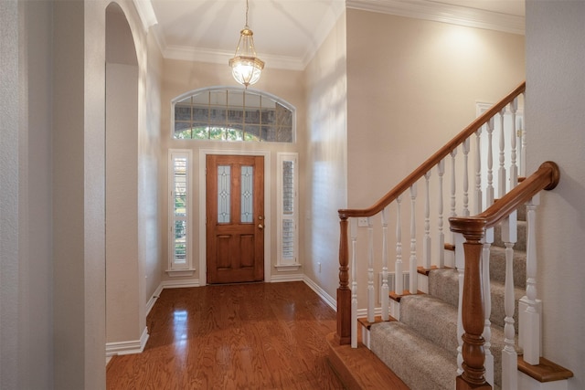 9 Park Place Ct, Wichita Falls, TX 76302 - entrance foyer featuring wood finished floors, crown molding, stairway, baseboards, and a high ceiling
