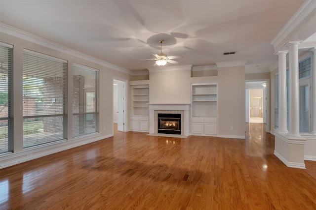 9 Park Place Ct, Wichita Falls, TX 76302 - unfurnished living room featuring decorative columns, ceiling fan, light wood finished floors, ornamental molding, and a tile fireplace