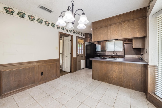 4508 Ramsgate Ct, Arlington, TX 76013 - kitchen featuring a chandelier, a sink, wainscoting, stainless steel gas stovetop, and freestanding refrigerator