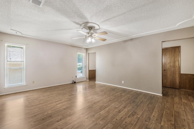 4508 Ramsgate Ct, Arlington, TX 76013 - unfurnished room with ceiling fan, wood finished floors, a textured ceiling, and baseboards
