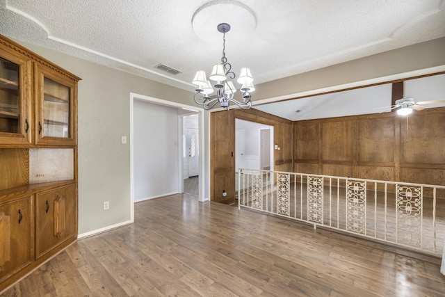 4508 Ramsgate Ct, Arlington, TX 76013 - empty room with a chandelier, a textured ceiling, wood finished floors, lofted ceiling, and ceiling fan