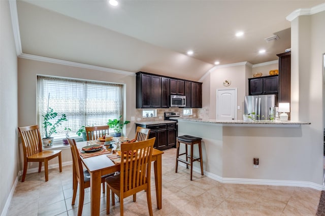11408 Aquilla Dr, Frisco, TX 75036 - dining area featuring crown molding, lofted ceiling, baseboards, light tile patterned floors, and recessed lighting