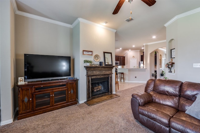 11408 Aquilla Dr, Frisco, TX 75036 - living area featuring a ceiling fan, arched walkways, crown molding, light carpet, and baseboards
