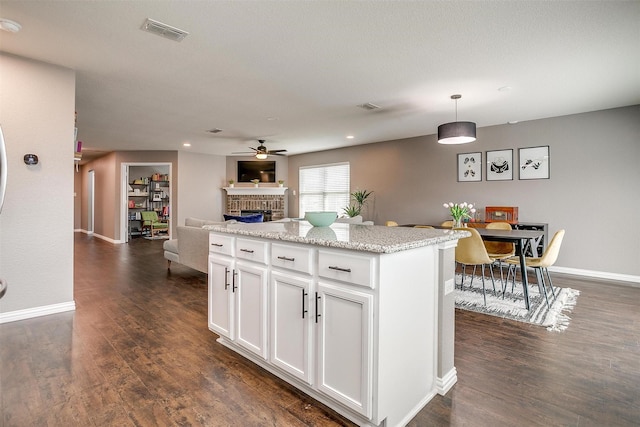2924 Whitetail Chase Dr, Fort Worth, TX 76108 - kitchen featuring a fireplace, a ceiling fan, white cabinets, dark wood-style flooring, and recessed lighting