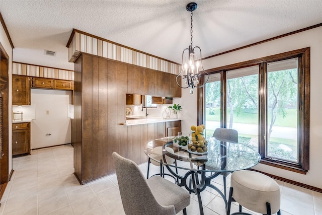 23 Crosslands Rd, Benbrook, TX 76132 - dining room with a chandelier, healthy amount of natural light, a textured ceiling, light tile patterned floors, and crown molding