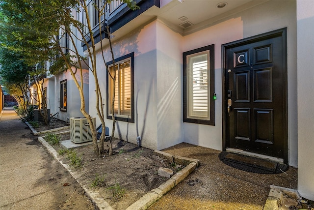 3320 Douglas Ave Unit C, Dallas, TX 75219 - view of exterior entry featuring stucco siding and central AC