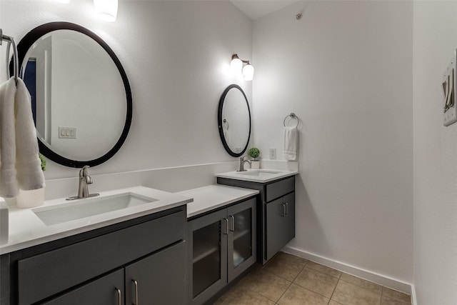 3320 Douglas Ave Unit C, Dallas, TX 75219 - full bath with two vanities, tile patterned floors, and baseboards