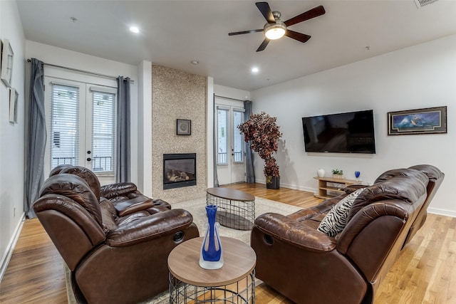 3320 Douglas Ave Unit C, Dallas, TX 75219 - living room featuring wood finished floors, ceiling fan, baseboards, a fireplace, and recessed lighting