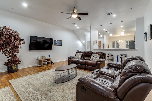 3320 Douglas Ave Unit C, Dallas, TX 75219 - living room featuring wood finished floors, a ceiling fan, baseboards, recessed lighting, and a chandelier