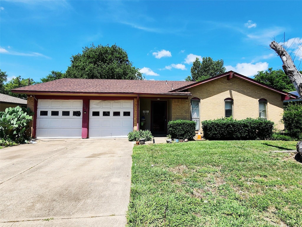 327 Teakwood St, Mesquite, TX 75149 - ranch-style home with a garage, driveway, a front lawn, and brick siding