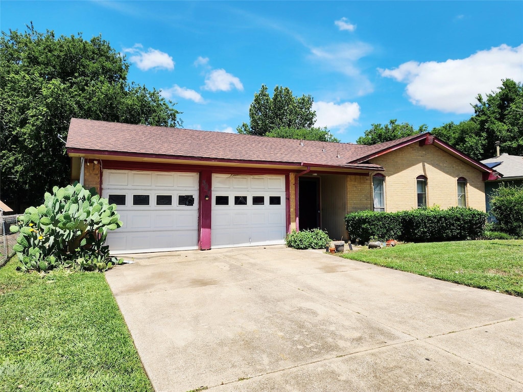 327 Teakwood St, Mesquite, TX 75149 - single story home featuring a garage, driveway, a front lawn, brick siding, and a shingled roof
