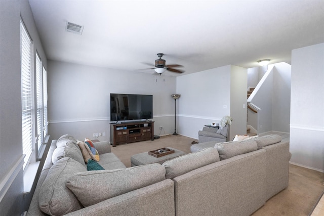 10940 Dillon St, Fort Worth, TX 76179 - living area featuring stairway, a ceiling fan, baseboards, and light colored carpet