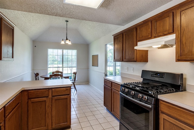 1721 Chapman Dr, Mesquite, TX 75149 - kitchen featuring black gas range, under cabinet range hood, a textured ceiling, light tile patterned floors, and light countertops