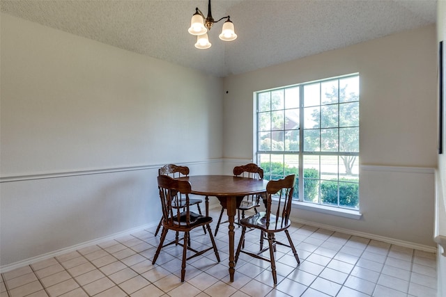 1721 Chapman Dr, Mesquite, TX 75149 - dining room with a textured ceiling, a chandelier, baseboards, and light tile patterned flooring