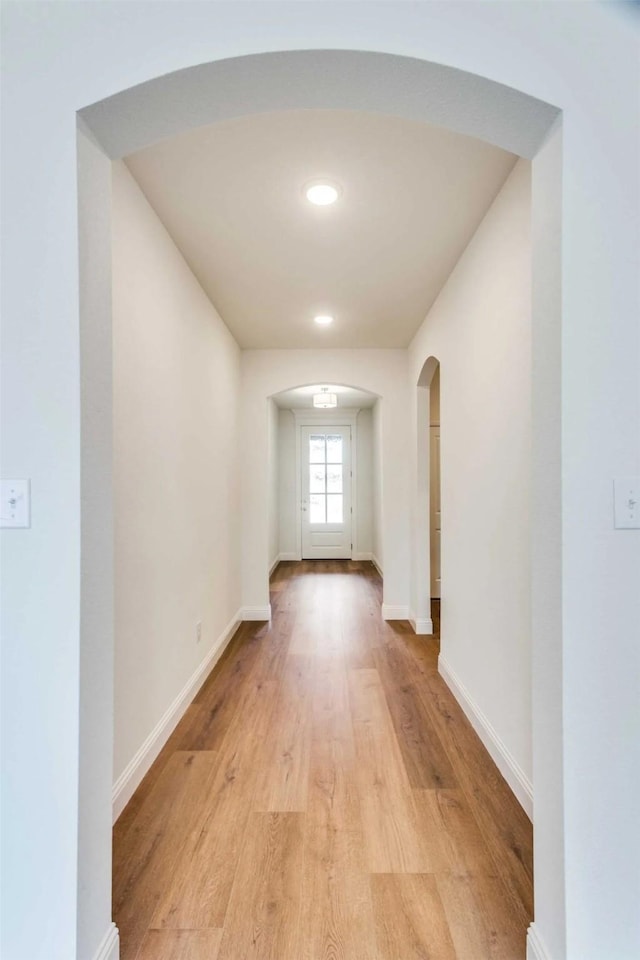 514 Hillcrest Cir, Justin, TX 76247 - hall featuring arched walkways, light wood-style floors, baseboards, and recessed lighting