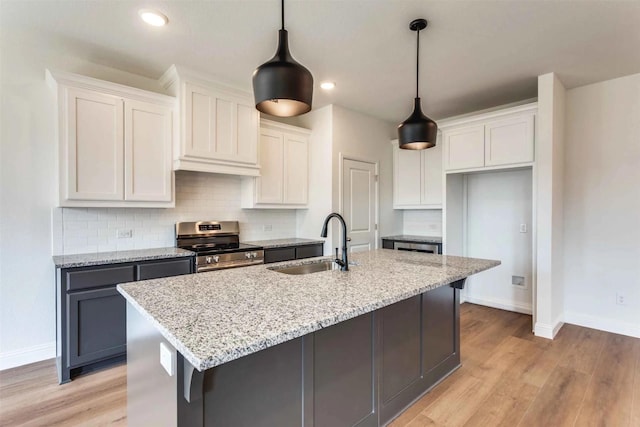 514 Hillcrest Cir, Justin, TX 76247 - kitchen with electric stove, a sink, baseboards, decorative backsplash, and white cabinets