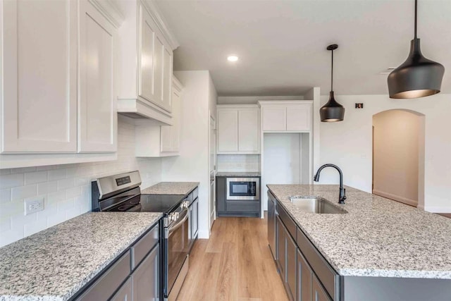 514 Hillcrest Cir, Justin, TX 76247 - kitchen with appliances with stainless steel finishes, a sink, white cabinets, tasteful backsplash, and a kitchen island with sink