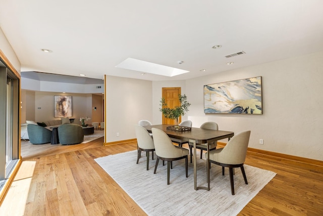 8907 Meadowknoll Dr, Dallas, TX 75243 - dining area featuring a skylight, light wood-style floors, baseboards, and recessed lighting