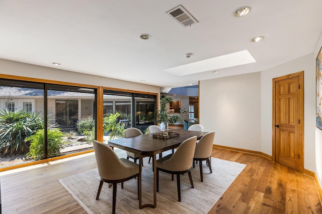 8907 Meadowknoll Dr, Dallas, TX 75243 - dining area with a skylight, baseboards, light wood finished floors, and recessed lighting