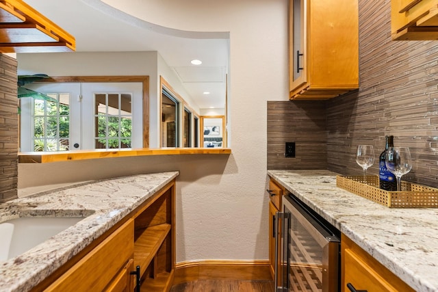 8907 Meadowknoll Dr, Dallas, TX 75243 - kitchen featuring wine cooler, baseboards, dark wood-style flooring, recessed lighting, and light stone countertops