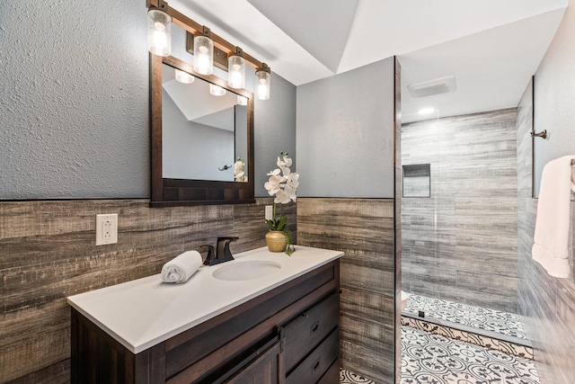 8907 Meadowknoll Dr, Dallas, TX 75243 - bathroom with vanity, tile walls, and a walk in shower