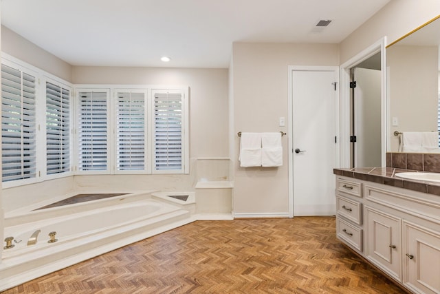 8907 Meadowknoll Dr, Dallas, TX 75243 - bathroom with vanity, a garden tub, and recessed lighting