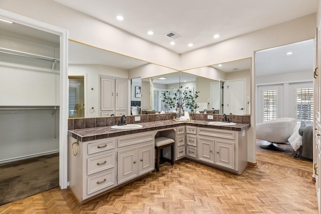 8907 Meadowknoll Dr, Dallas, TX 75243 - ensuite bathroom with double vanity, recessed lighting, and a walk in closet